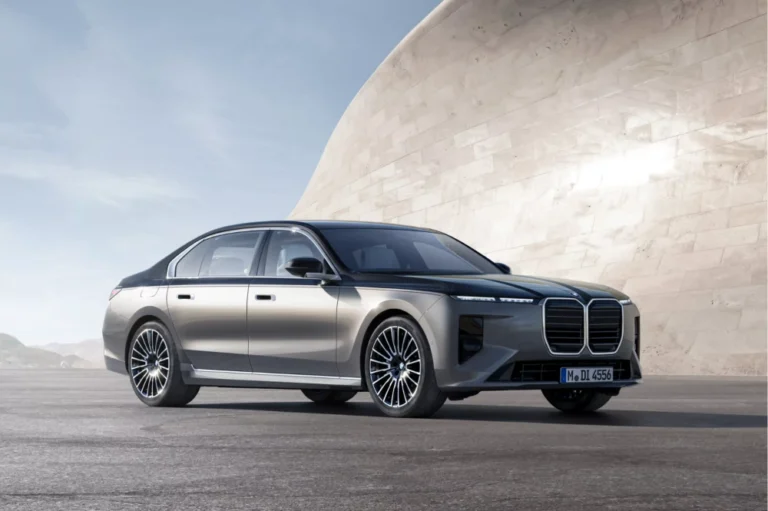 A BMW 7 series sedan parked in a slightly shaded area