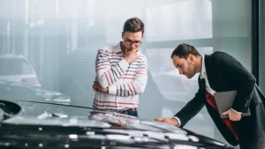 Staff inspecting a new car during its first service